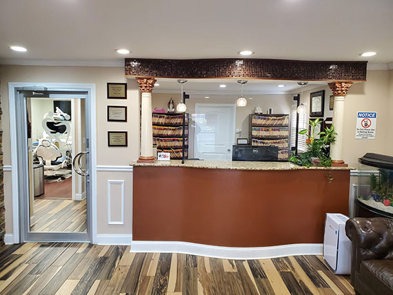 An interior view of a well-lit, modern storefront with a counter and a sign that reads  Pet Grooming .