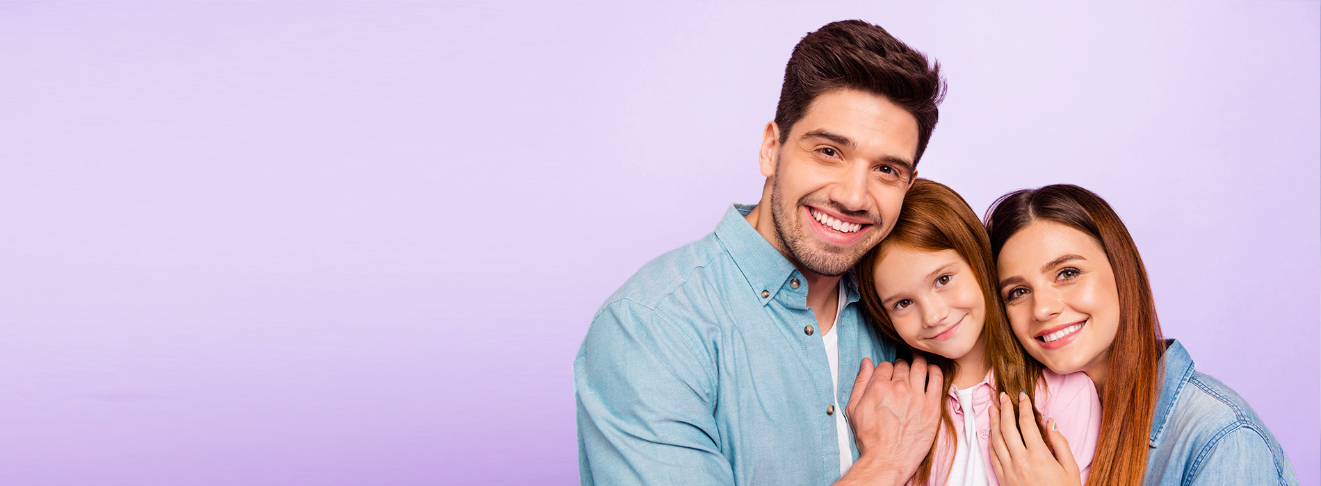 The image features a family of four, consisting of a man, a woman, and two young girls, smiling and posing together against a purple background.